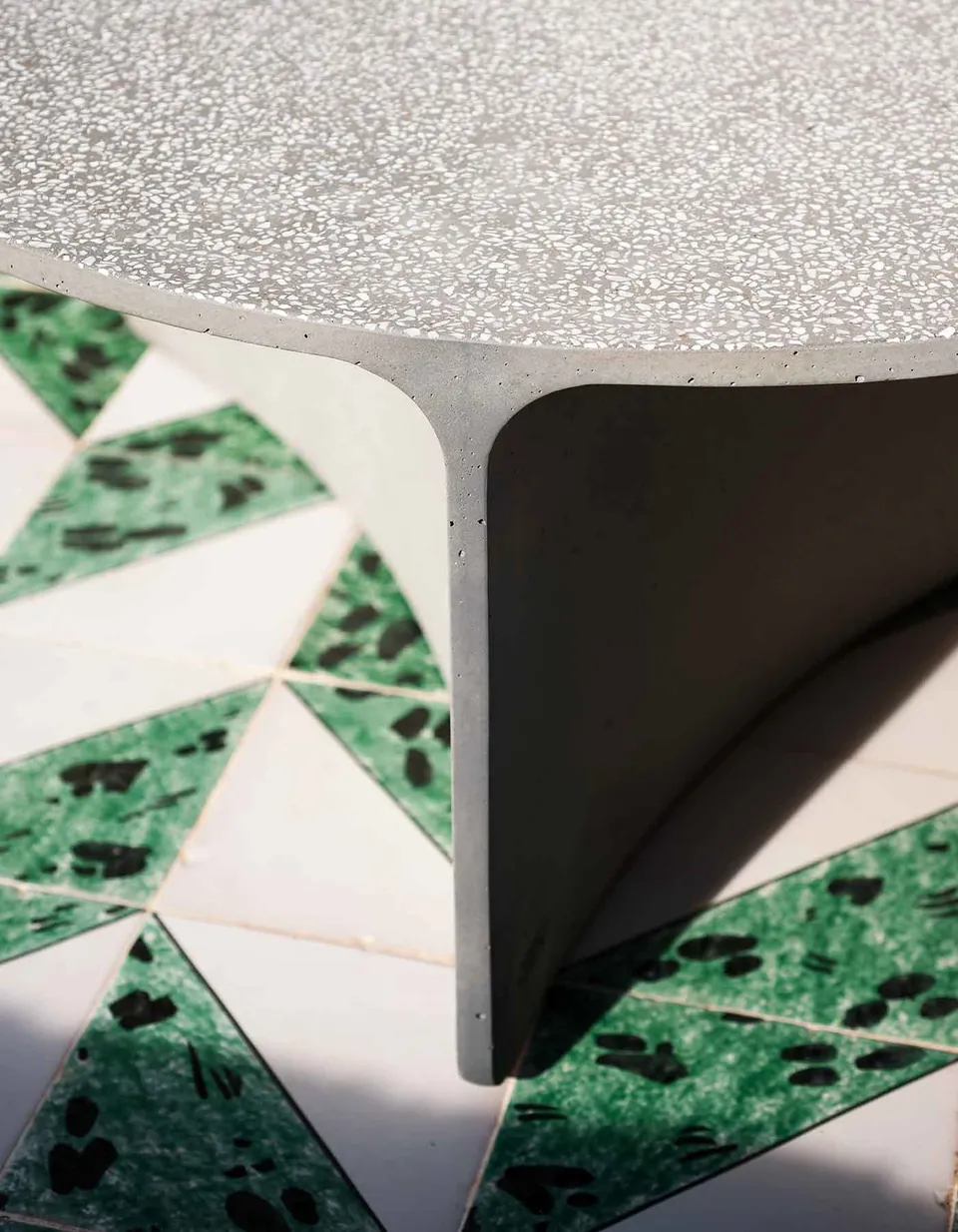 RODA Aspic concrete tables grouped on a terrace, RODA patio furniture catalog photograph