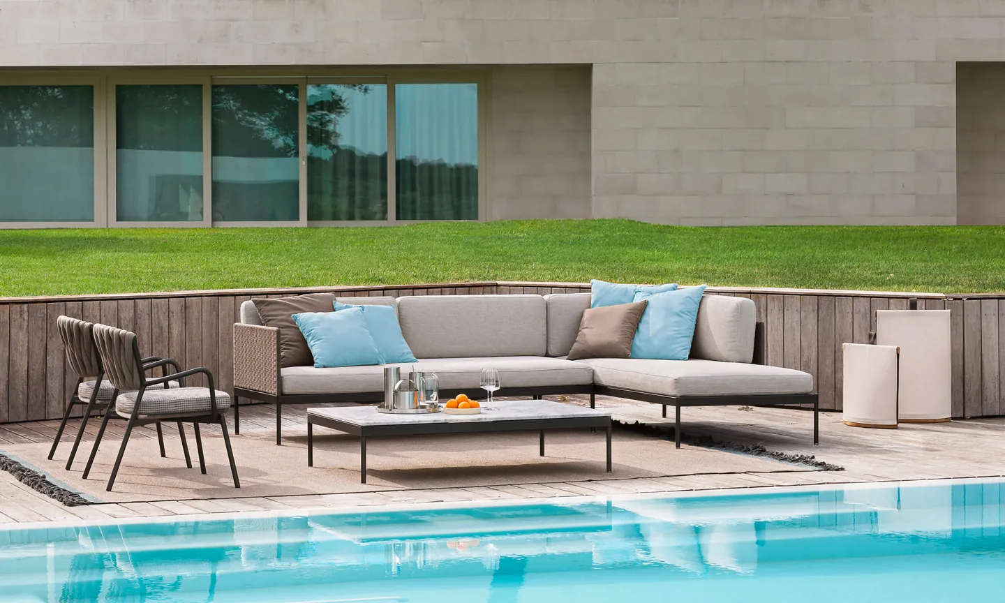 RODA Basket modular sofa with stone coffee table on a terrace, RODA patio furniture catalog photograph