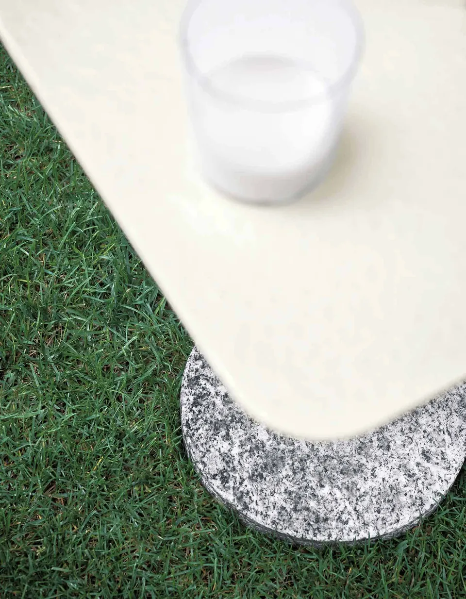 RODA Bernardo side tables beside a lounge chair, RODA outdoor furniture catalog photograph