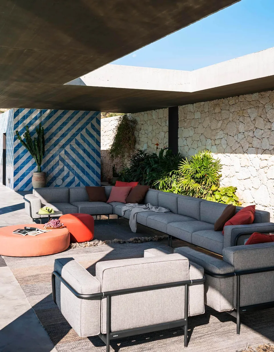 RODA Estendo corner sofa with stone-topped coffee table on a terrace, modular aluminum sofa catalog photograph