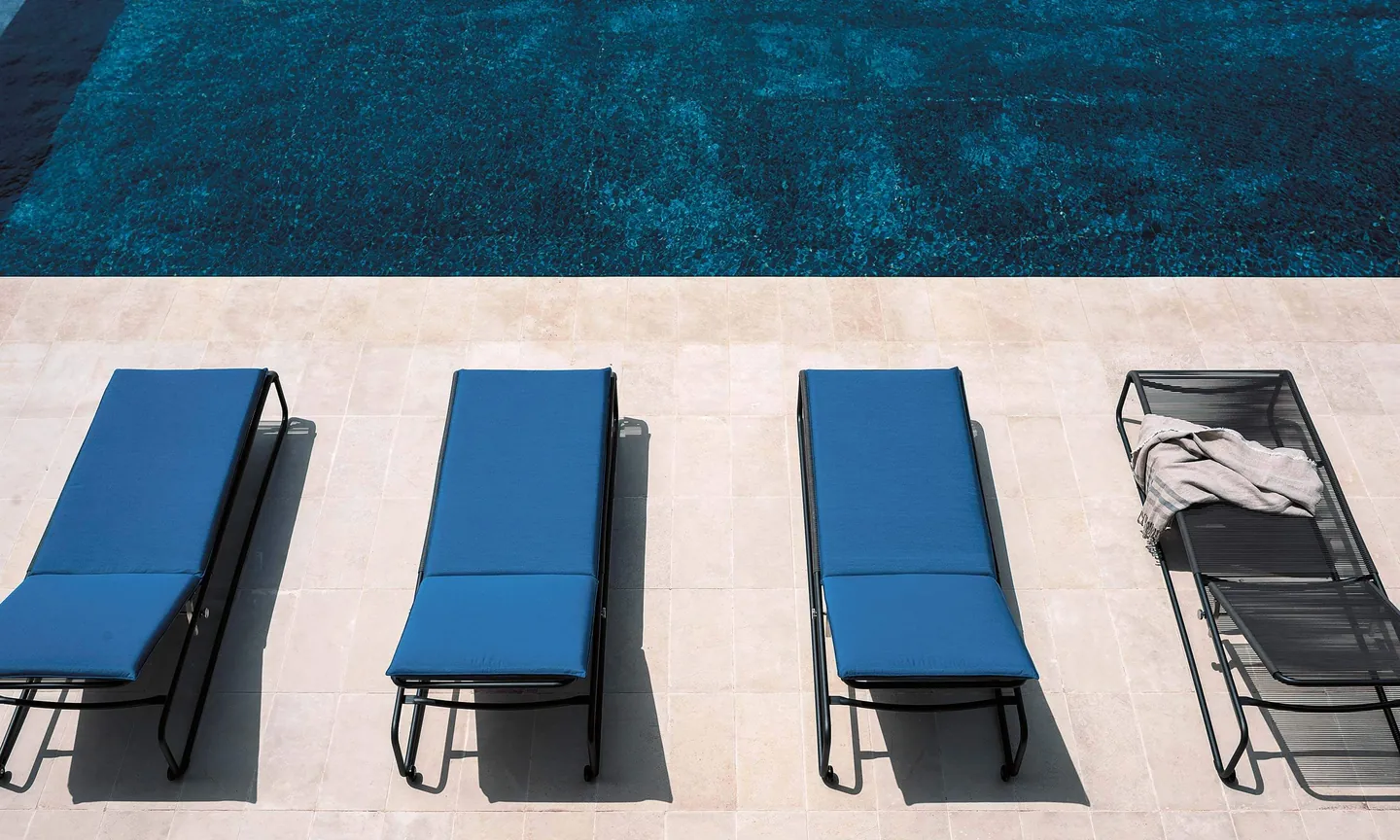 RODA Harp armchairs and barstools on a terrace, corded outdoor chair catalog photograph