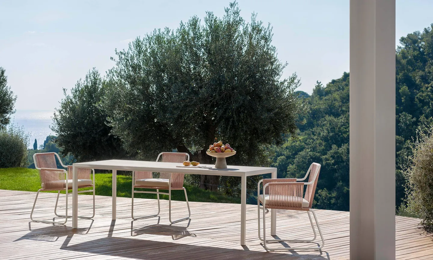 RODA Plein Air dining table and armchairs outdoors, RODA patio furniture catalog photograph