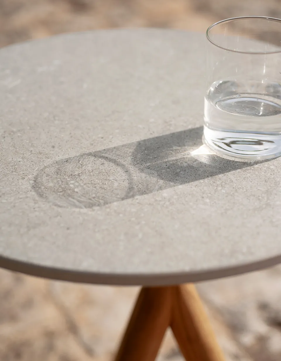 RODA Stork teak side table beside outdoor seating, RODA furniture catalog photograph
