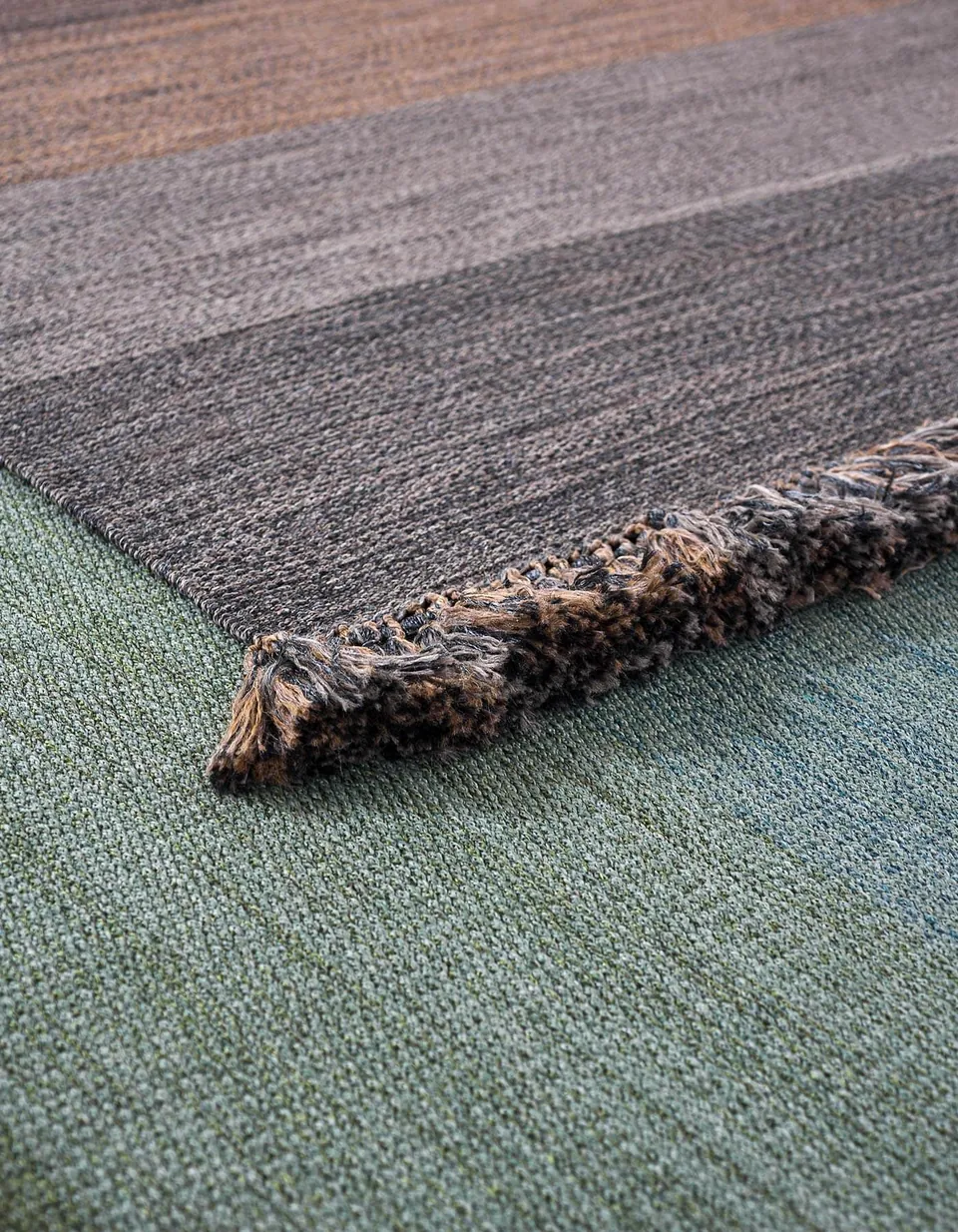 RODA Tint outdoor rug under a lounge group on a terrace, RODA outdoor furniture catalog photograph