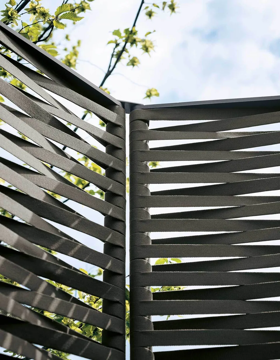 RODA Wing screens dividing a terrace behind outdoor seating, RODA patio furniture catalog photograph